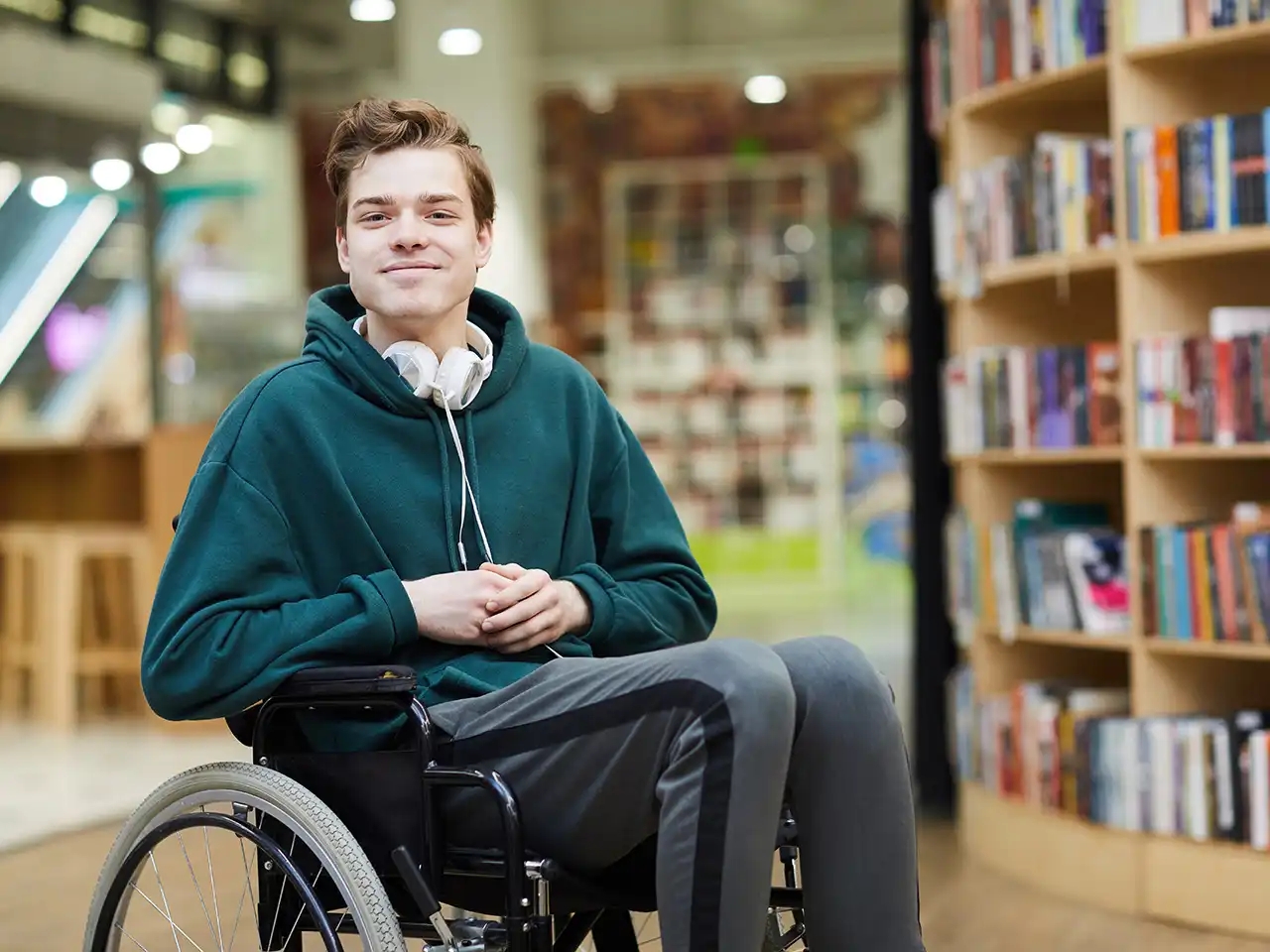 Young man in wheel chair at library