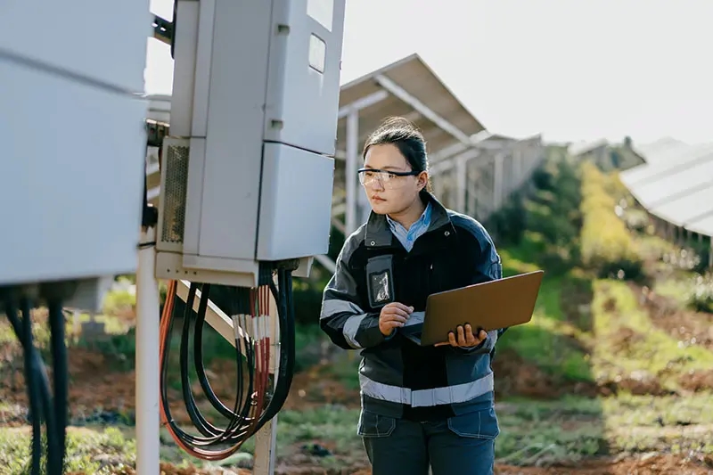Ingeniera asiática trabajando en una central solar